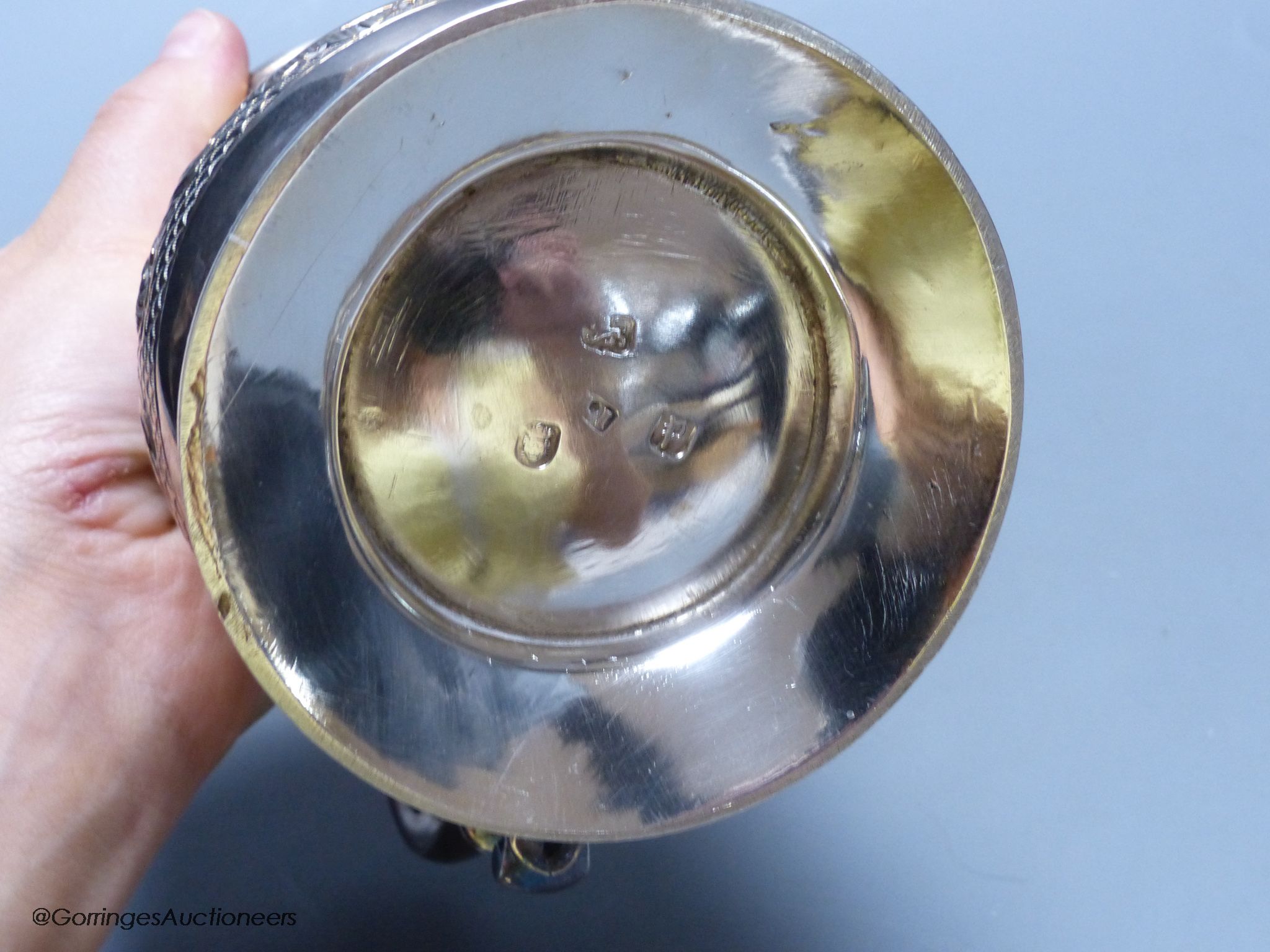 A George III silver baluster mug, with later embossed decoration, London, 1770, 12.7cm, 12.5 oz, indistinct maker's mark.